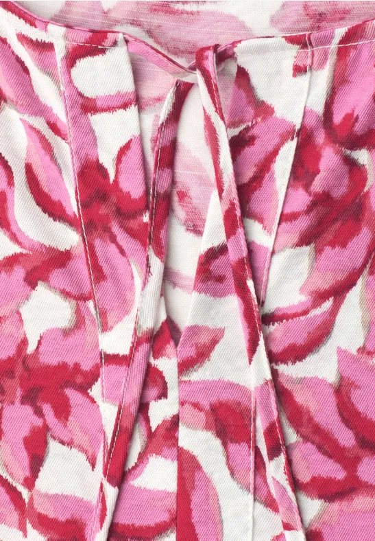 Gros plan d'un tissu à fleurs rose et blanc avec des plis délicats