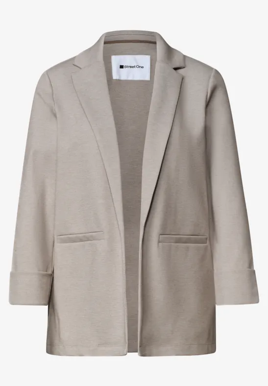 Blazer beige décontracté à coupe ouverte et poches plaquées.