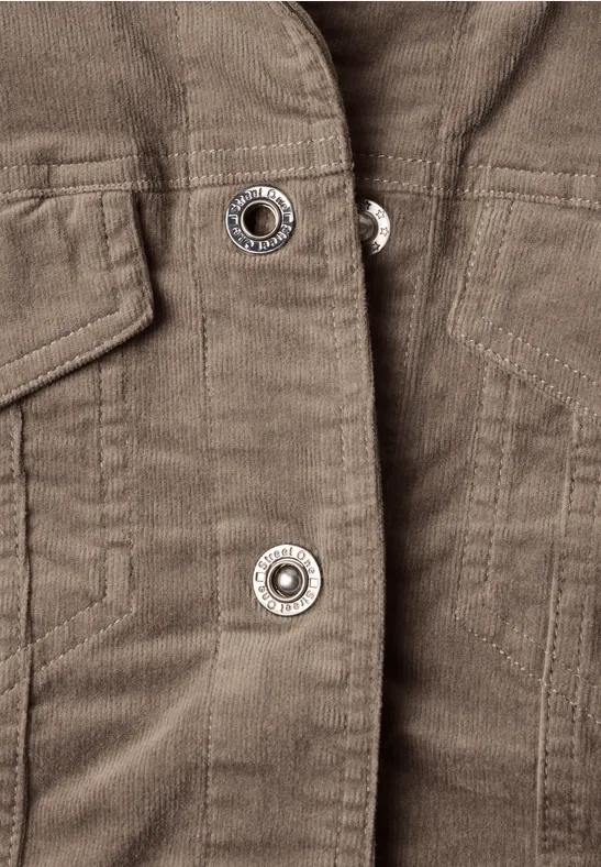 Nahaufnahme einer braunen Cordjacke mit Metall-Druckknöpfen.