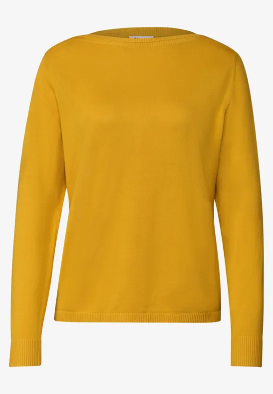 Ein gelber Pullover mit langen Ärmeln.