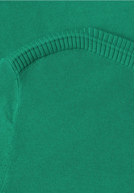 Nahaufnahme eines grünen Strickstoffs mit verstärkter Naht