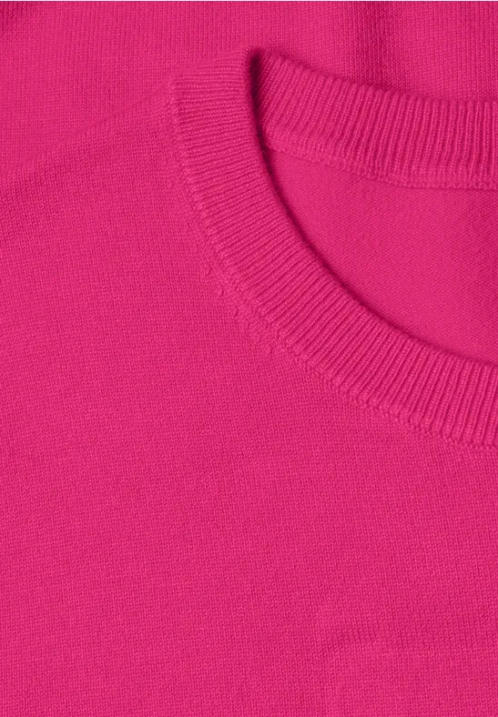 Nahaufnahme eines pinken T-Shirt-Kragens mit feiner Rippstruktur und Saumnaht.