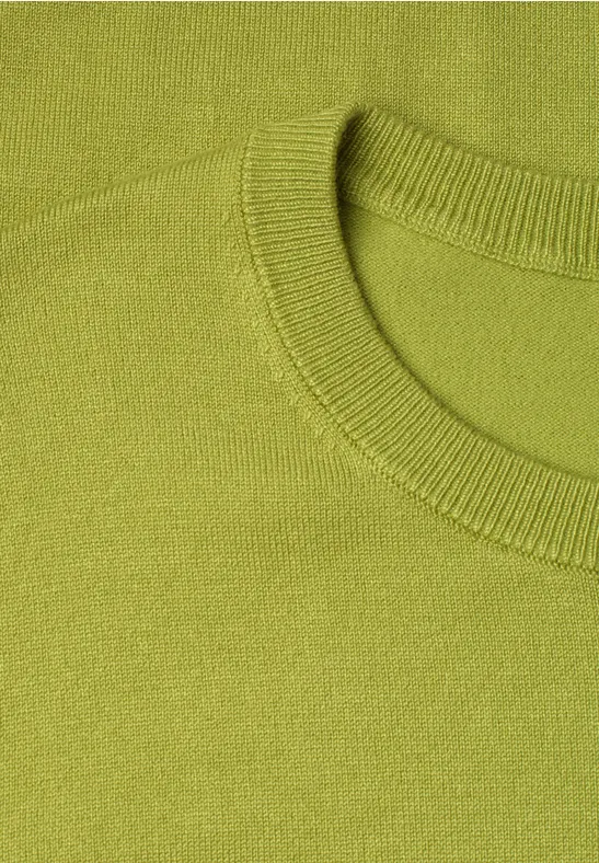 Nahaufnahme eines hellgrünen Pullovers mit Rundhalsausschnitt und feiner Strickstruktur.