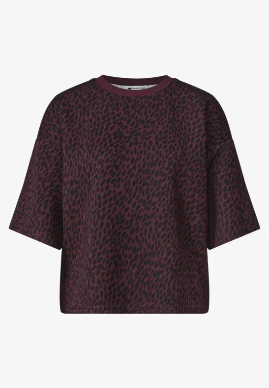 T-shirt oversize à manches courtes, couleur pourpre foncé à motif noir irrégulier.