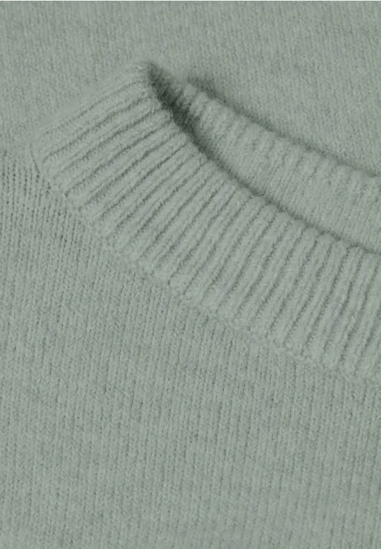 Nahaufnahme eines hellgrün-grauen Strickpullovers mit rundem, geripptem Kragen.