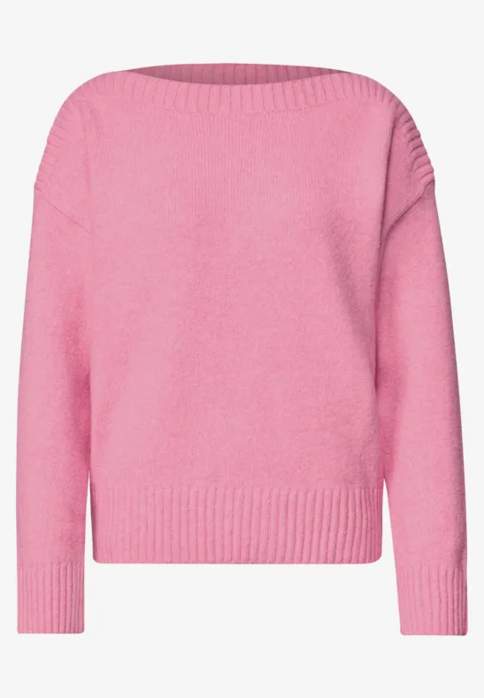 Różowy sweter z długimi rękawami z dzianiny.