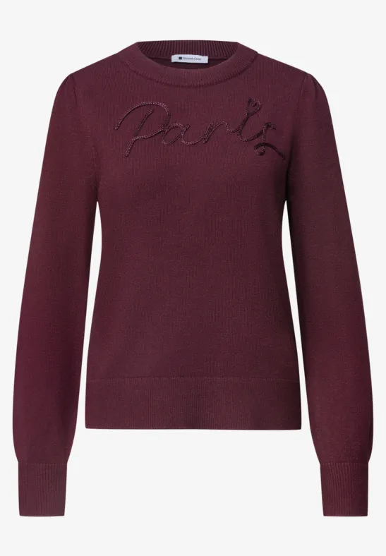 Pull bordeaux col rond avec inscription 'Paris' sur la poitrine.