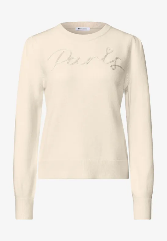 Pull crème à col rond, manches longues et broderie discrète en lettres sur la poitrine