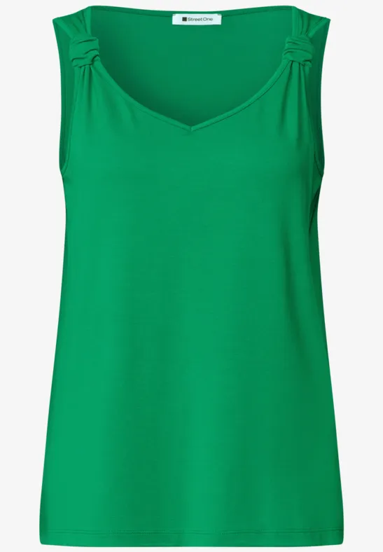 Haut sans manches féminin vert vif avec encolure en V et fronces aux épaules.