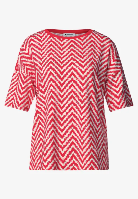 Rotes T-Shirt mit weißem Zickzackmuster und kurzen Ärmeln.