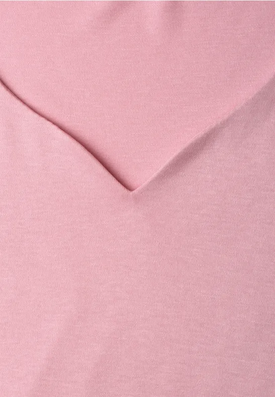 Ein rosa Stoff mit einer V-förmigen Falte.