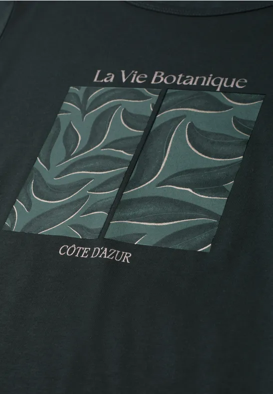 Zwart T-shirt met botanische print van groene bladeren en de teksten 'La Vie Botanique' en 'Côte d'Azur'.