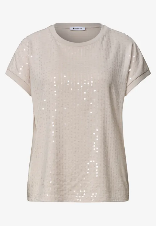 T-shirt beige à manches courtes orné de sequins, col rond et coupe décontractée.