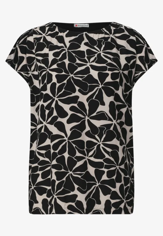 Zwart-witte dames top met korte mouwen en groot bloemenpatroon.