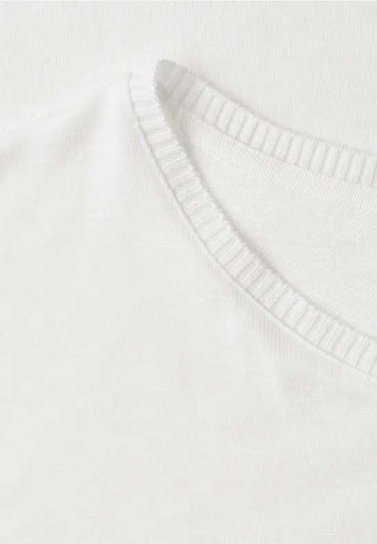 Gros plan sur un T-shirt blanc avec encolure ronde.
