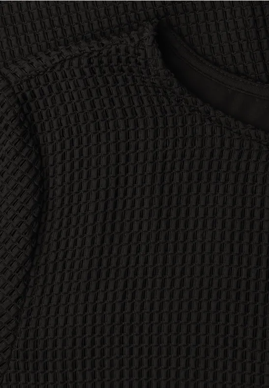 Schwarzer, strukturiert gewebter Waffelstrickstoff mit feiner Musterung.