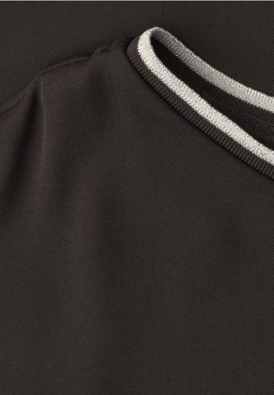 Nahaufnahme eines schwarzen Sweatshirt-Kragens mit weißen und grauen Streifen.