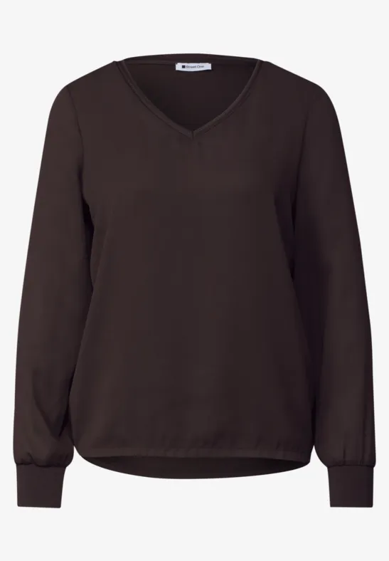 Dunkelbraune Damenbluse mit V-Ausschnitt und langen Ärmeln, legerem Schnitt und elastischen Bündchen.