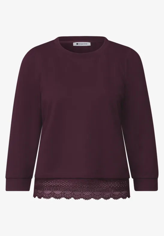 Dunkelvioletter Pullover mit Spitzenbesatz am Saum, Rundhalsausschnitt und langen Ärmeln.