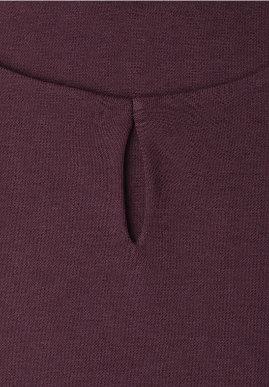 Close-up van bordeauxrode stof met een kleine verticale split