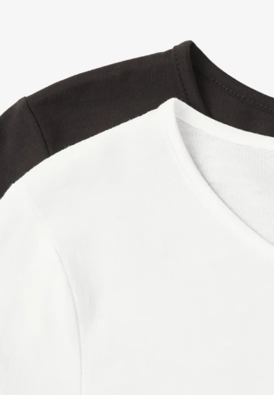 Schlichtes weißes und schwarzes T-Shirt aus Baumwolle, übereinander gelegt.