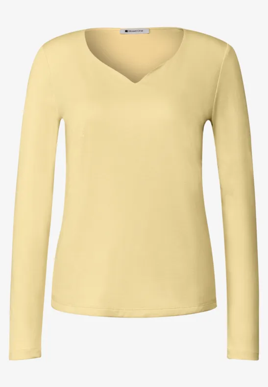 Haut femme citron clair à manches longues et col en V, épuré et élégant.
