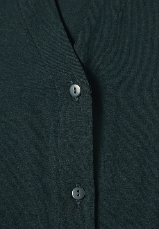 Close-up van een donker vest met V-hals en knoopsluiting