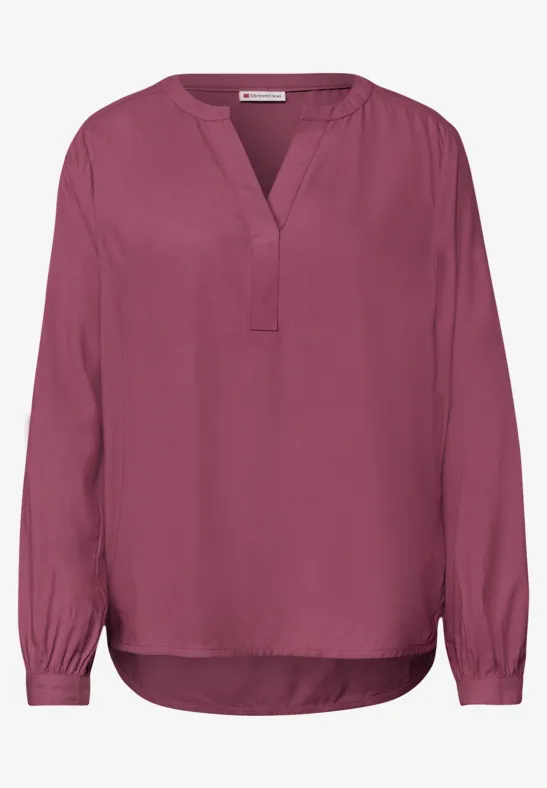 Damenbluse mit langen Ärmeln und V-Ausschnitt in kräftigem Pink.