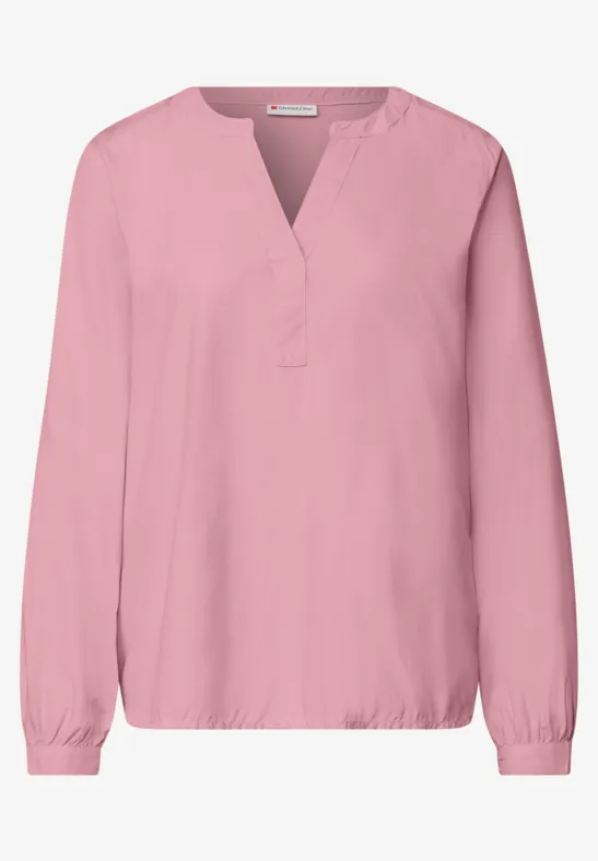 Rosa Bluse mit V-Ausschnitt, langen Ärmeln und elastischen Bündchen.