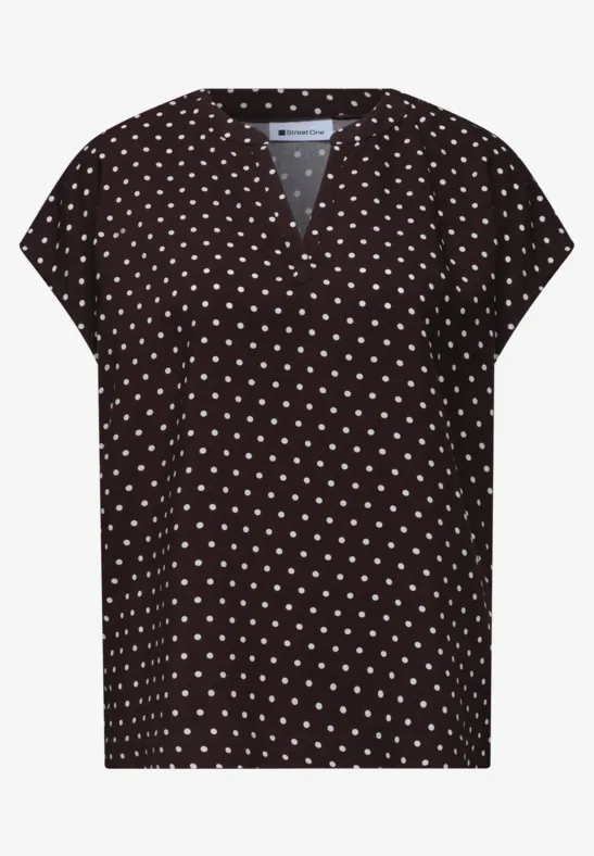 T-shirt femme noir à manches courtes, col V et imprimé à pois blancs.