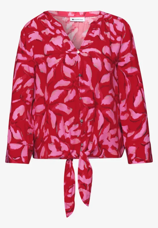 Rode blouse met roze bladprint, V-hals, lange mouwen en strikdetail aan de taille.