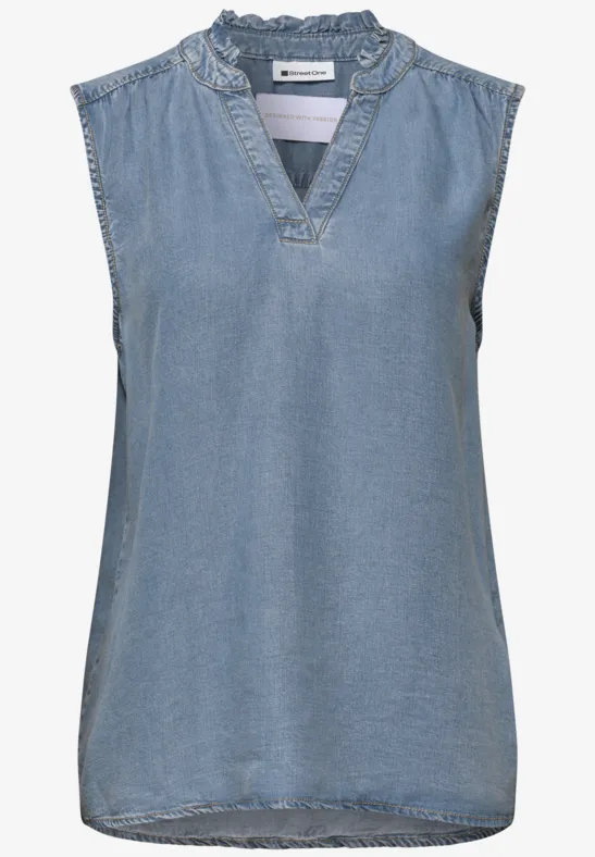 Ärmellose Jeansbluse mit V-Ausschnitt und verspieltem Rüschenkragen.