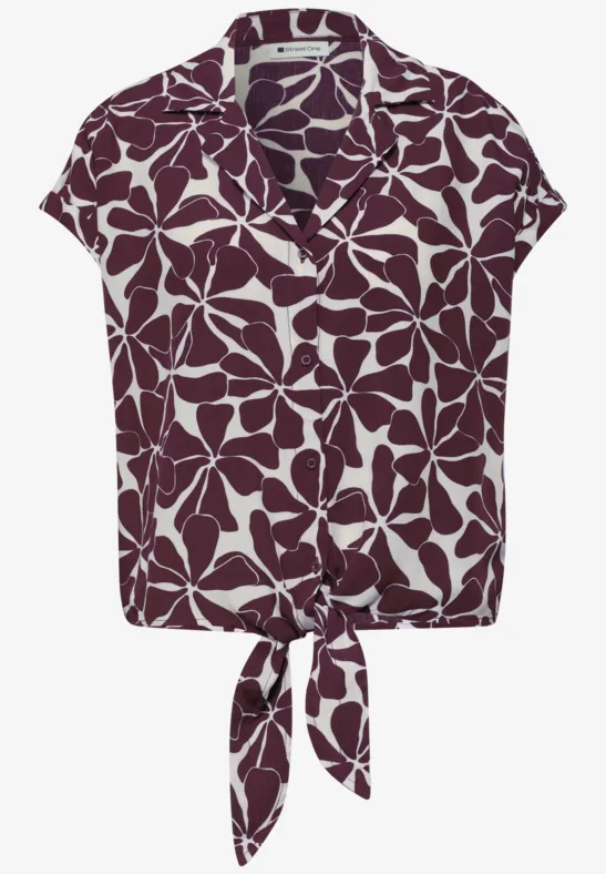Kort mouwblouse met kraag, wit bladmotief op paarse achtergrond en knoop in de taille.