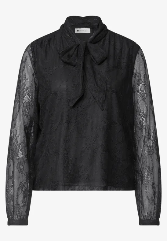 Eine schwarze Spitzenbluse mit langen Ärmeln und Schleifendetail am Kragen.
