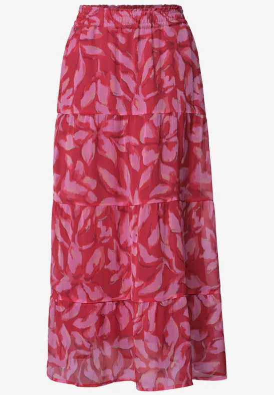 Rode lange rok met roze bladprint, elastische taille en plissé volant.