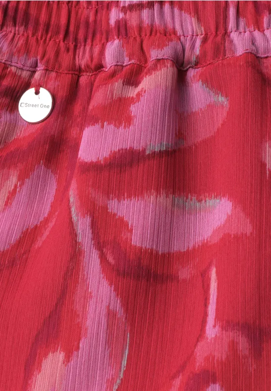 Rode rok met elastische taille en abstract roze-fuchsia patroon, klein hartlabel.