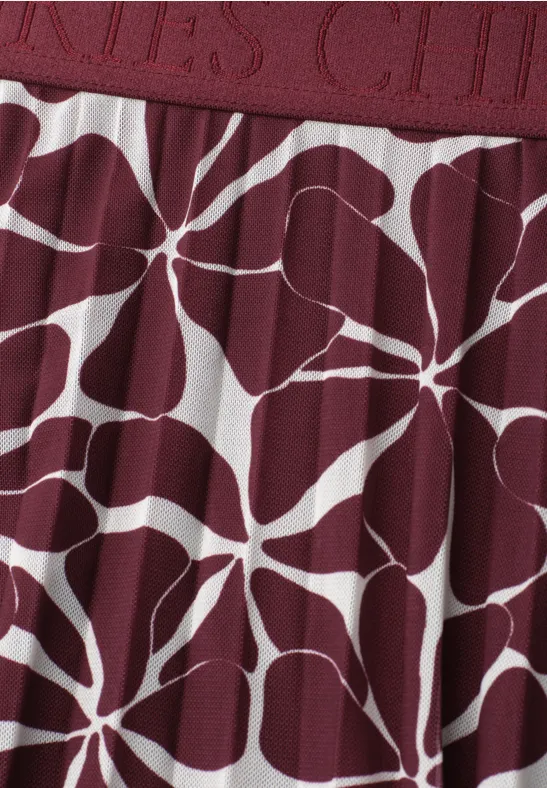 Bordeauxrode stof met wit organisch bloem- of sterrenpatroon.