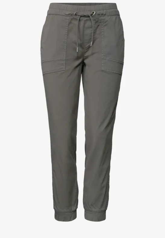 Pantalon femme décontracté gris avec cordon de serrage, poches plaquées et bas élastiques.