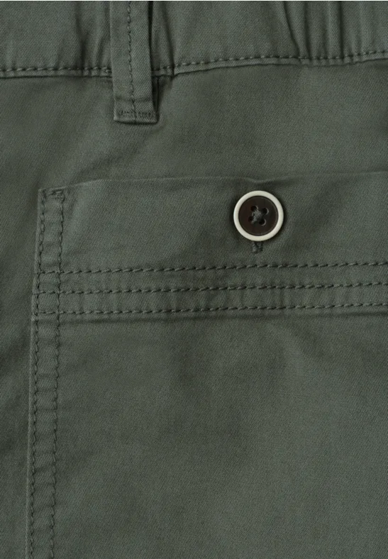 Nahaufnahme einer grünen Hose mit seitlicher Tasche und Knopf.