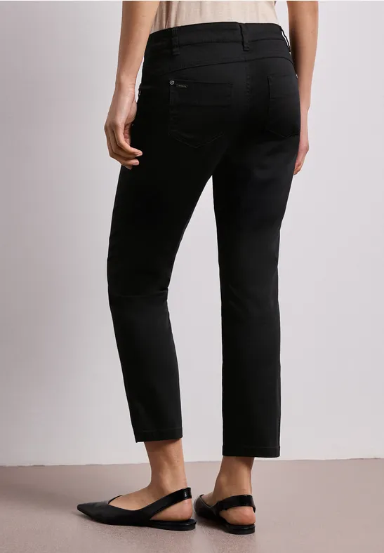 Schwarze, knöchellange Hose im schmalen Schnitt mit Gesäßtaschen, kombiniert mit schwarzen Slingback-Ballerinas.