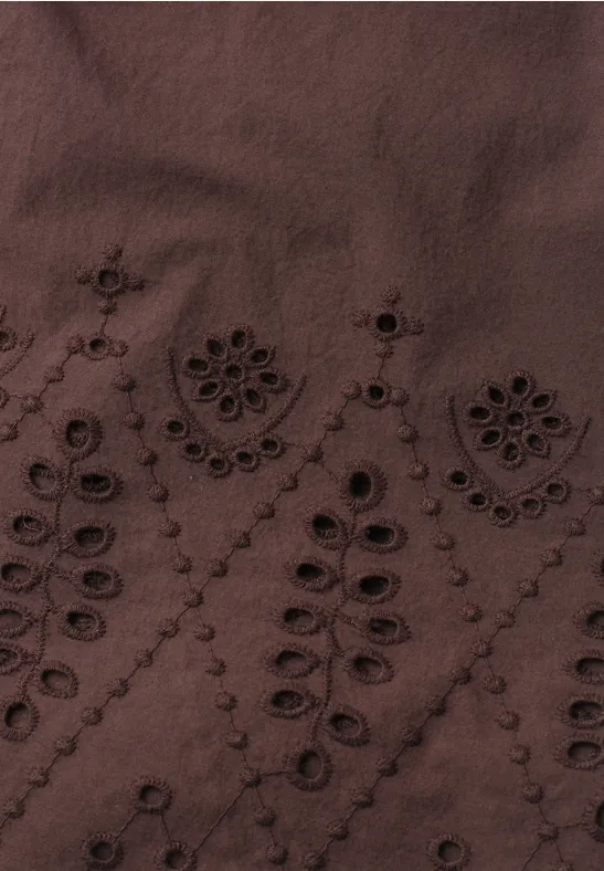 Tissu brun foncé avec délicats motifs floraux brodés et ajourés