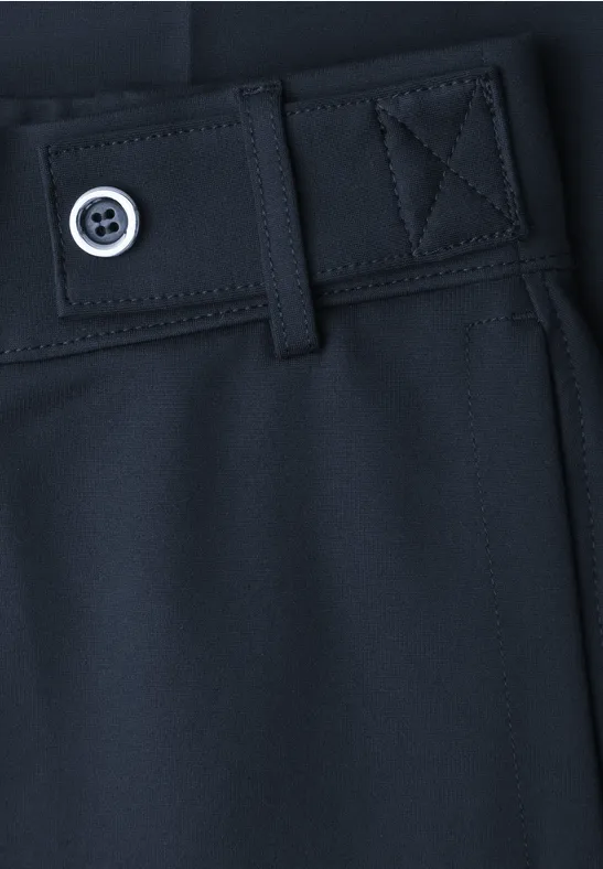 Nahaufnahme einer dunkelblauen Hose mit Gürtelöse und Knopfdetail.