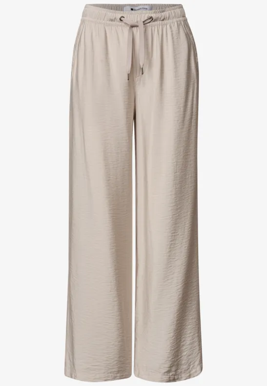 Beige weite Hose aus leichtem, strukturiertem Stoff mit elastischem Bund und Kordelzug