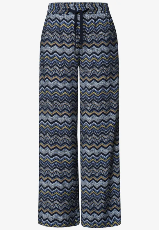 Weite, locker sitzende Hose mit blau-grauem Zickzackmuster und elastischem Bund sowie Kordelzug.