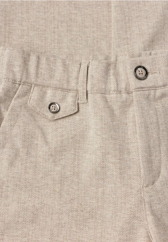 Beige broek van fijne stof met tailleband, riemlussen en opgestikte zakken met knopen.