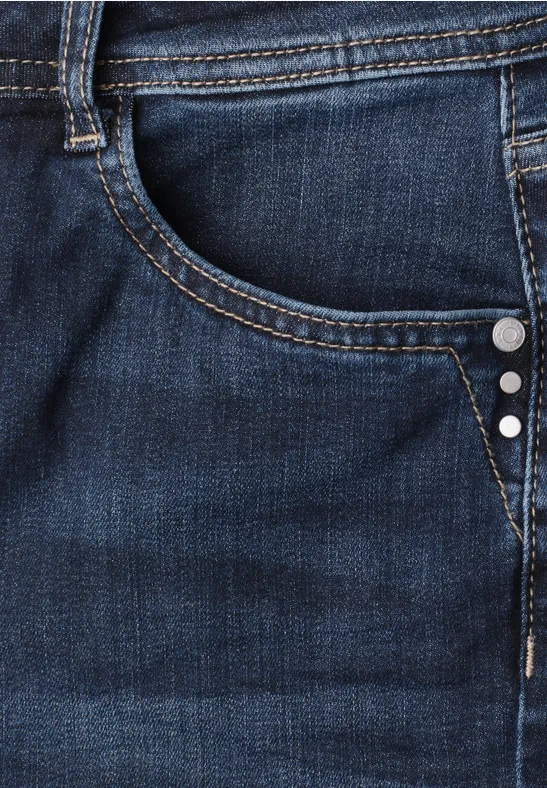 Dunkle Jeans mit aufgesetzter Tasche, Gürtelschlaufe, Ziernähten und Metallnieten.
