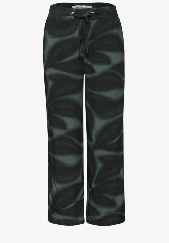 Lässige weite Hose mit grün-schwarzem abstraktem Wirbelmuster und Tunnelzugbund.