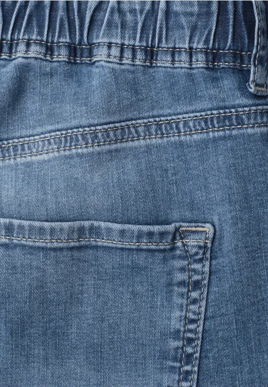 Nahaufnahme einer blauen Jeans mit Gesäßtasche und sichtbaren Nähten.