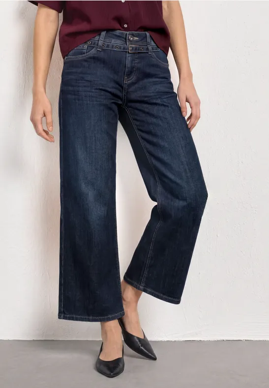Dunkle, hoch geschnittene, weite Cropped-Jeans mit spitzen Pumps kombiniert.