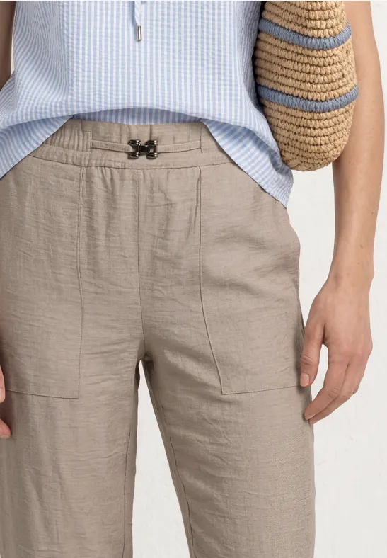 Beige Leinenhose mit elastischem Bund, Zierknopf und aufgesetzten Taschen.